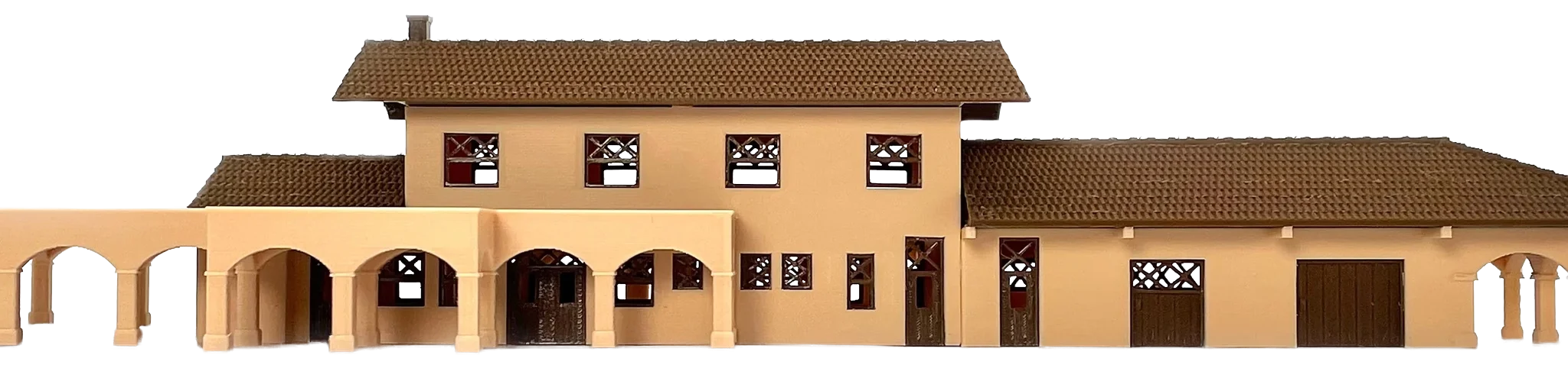 A 3D-printed architectural scale model of a mission-style building photographed straight on, tan walls with a brown tile roof and an arcade of arches running off both sides of the frame