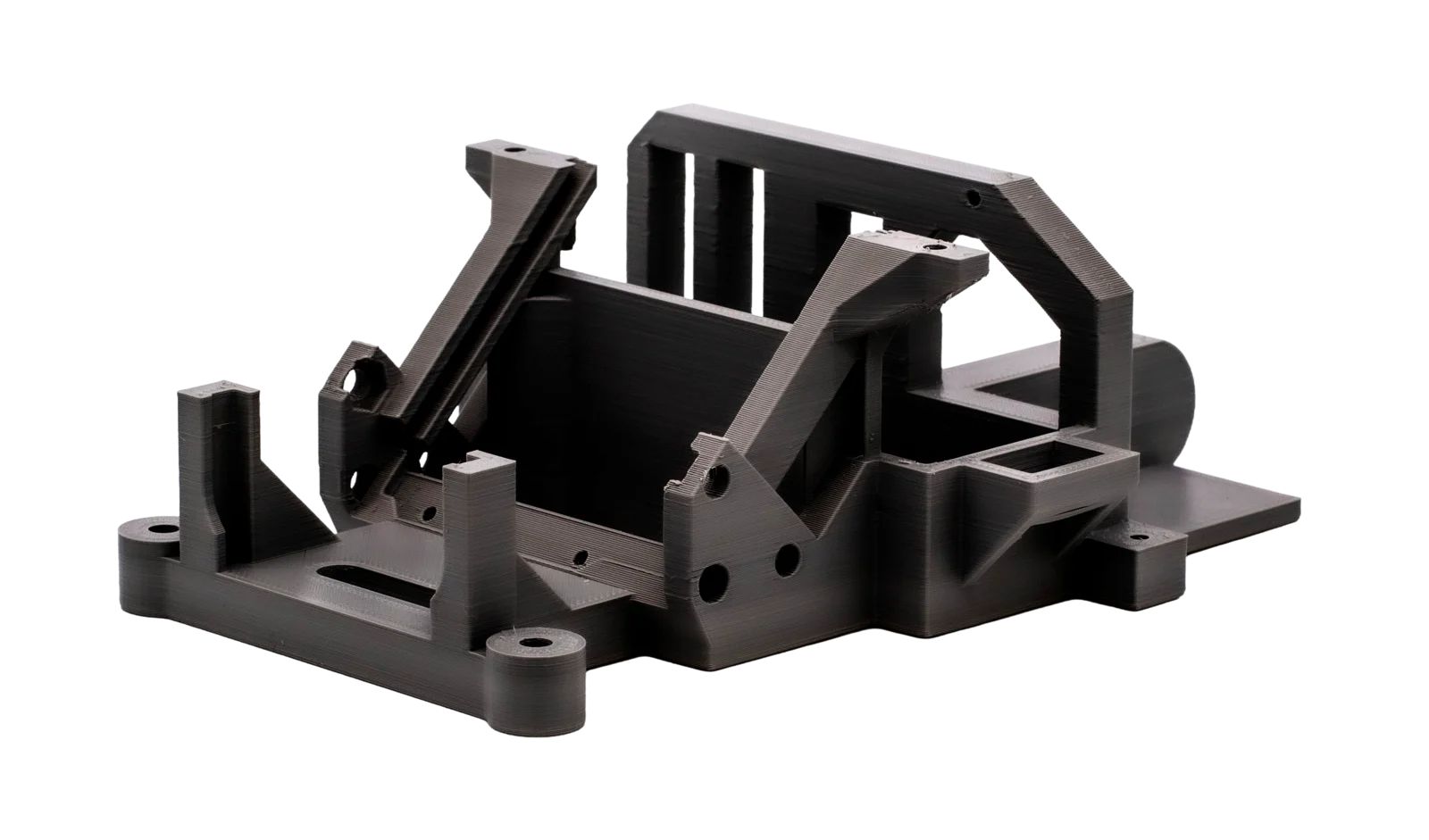 Black 3D-printed machine housing or frame structure with multiple mounting brackets and bores