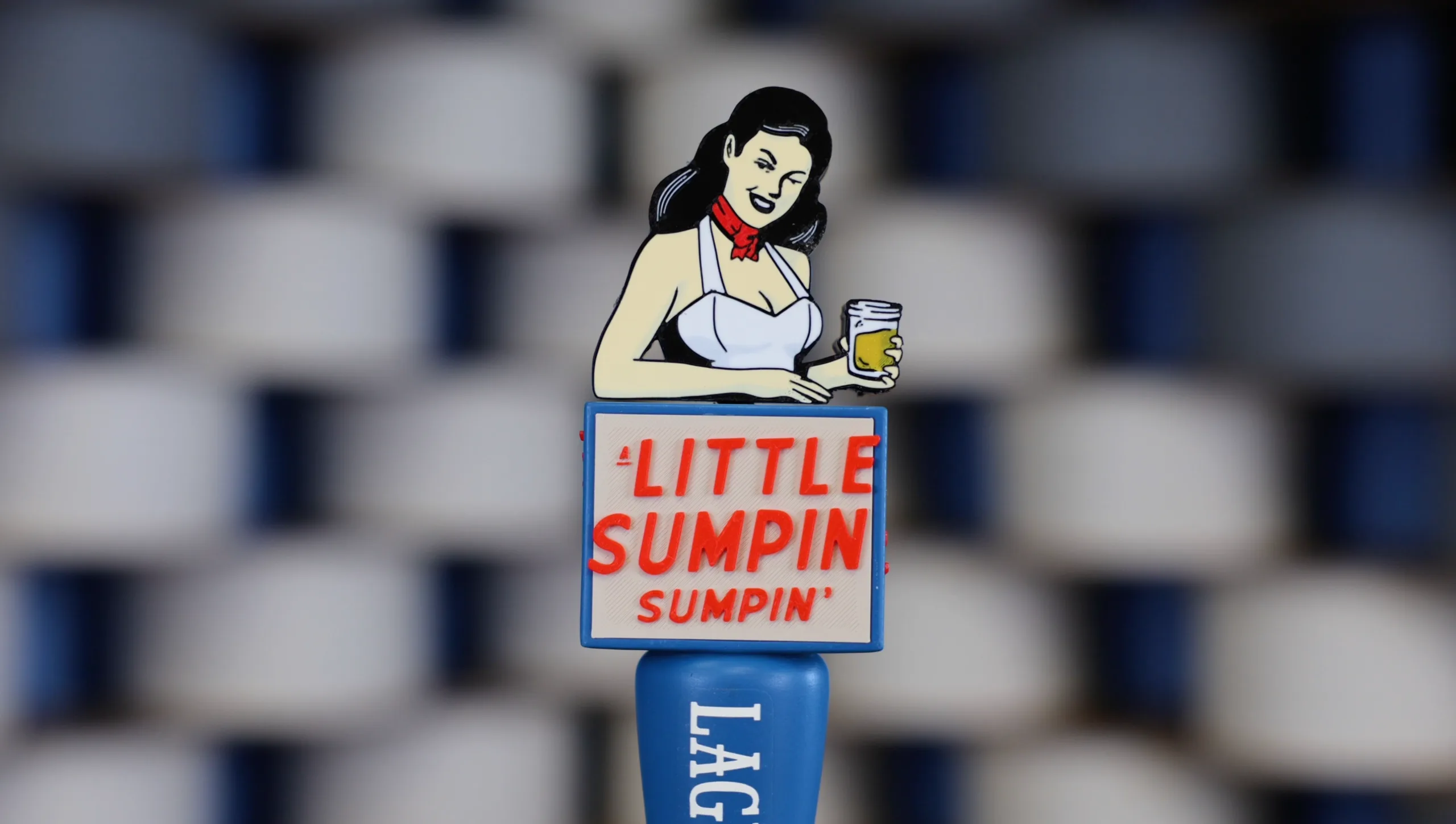 A custom 3D-printed Lagunitas A Little Sumpin Sumpin Ale tap handle against a blurred wall of tap handles